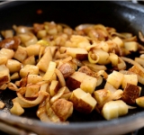 Добавляем к луку нарезанный картофель и томим овощи еще несколько минут.