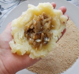 Из картофельного пюре в руках делаем лепешку, в центр укладываем начинку и формируем пирожок.