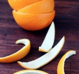 Тщательно моем апельсины, обдаем кипятком, чтобы смыть воск и очищаем кожуру. Для этого надрезаем кожуру по центру, чтобы получились две полусферы. Потом разрезаем каждую пополам, и каждую часть еще на 3 полоски.