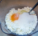 К творогу добавьте яичный желток и сахао. Перемешайте.	