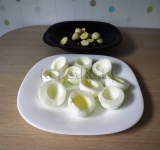 Яйца остужаем, чистим, разрезаем их пополам. Желтки вынимаем.