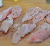 Филе курицы нарезаем на небольшие продолговатые кусочки, солим и перчим их со всех сторон.