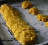 Смазываем противень маслом и просыпаем мукой. Аккуратно, при помощи ложкой выкладываем тесто в форме батона приблизительно длинной в 20 см. За время выпекания он вырастит в 2 раза. Мокрыми пальцами сглаживаем неровности. Ставим противень в предварительно разогретую до 170 градусов духовку и выпекаем батон в течение часа. Верх должен хорошо подрумяниться, а серединка подсушится. Из остатков теста можно испечь профитроли. Вынимаем противень из духовки и полностью остужаем батон.	