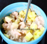 К промариновавшимся креветкам добавляем половину измельченных ананасов, перемешиваем.